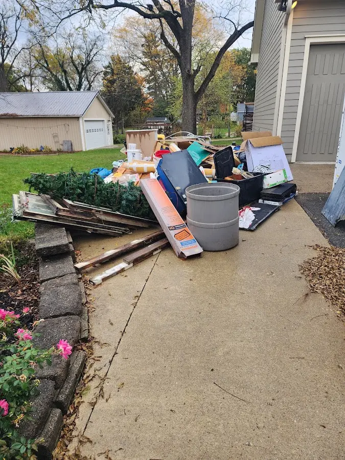 Dumpster being loaded with debris for Estate Cleanout Dumpster Rental in Lanham